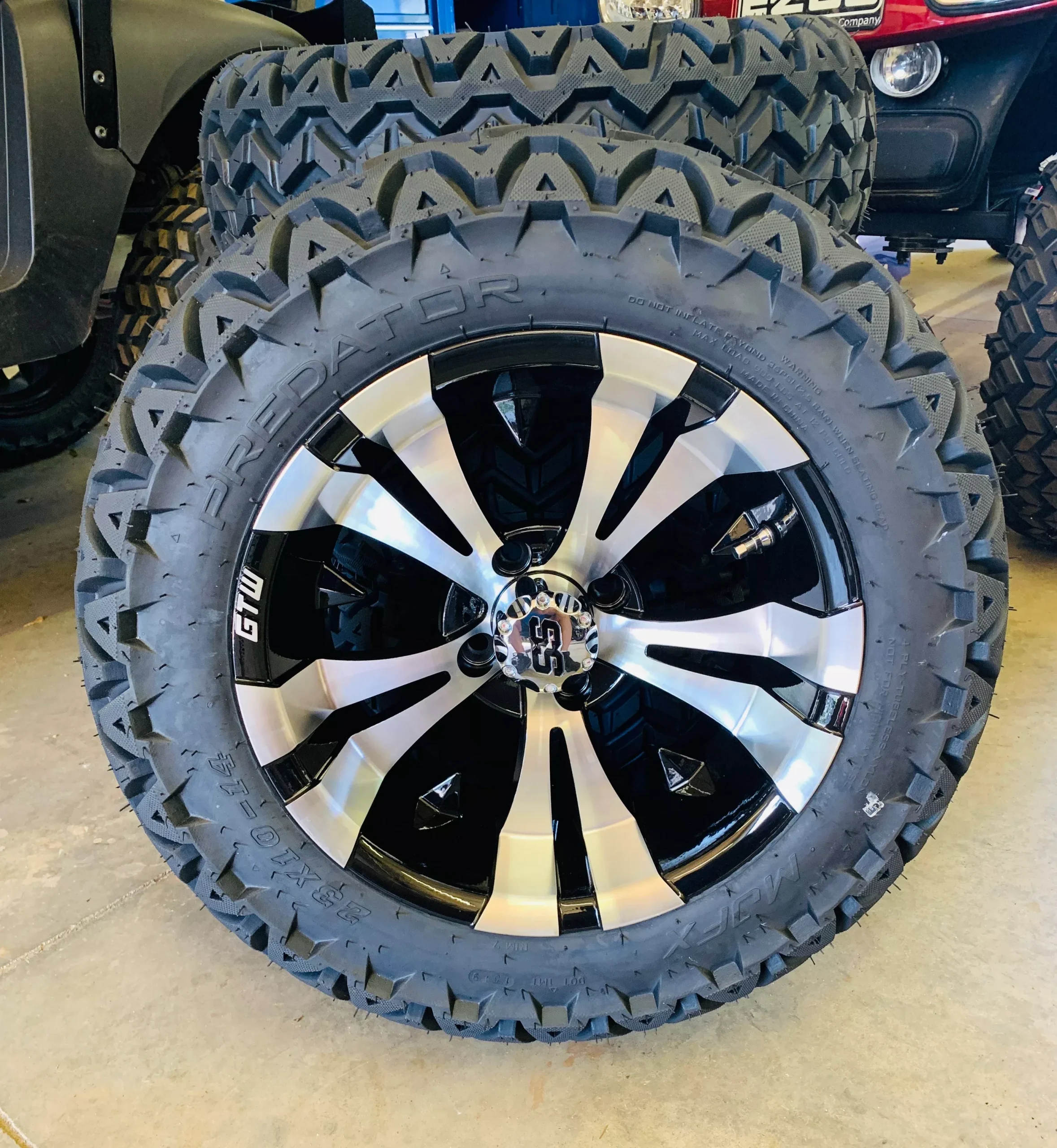 14" Vampire Black & Machine Aluminum Wheels with 23x10-14 All-Terrain Tires | Set of 4